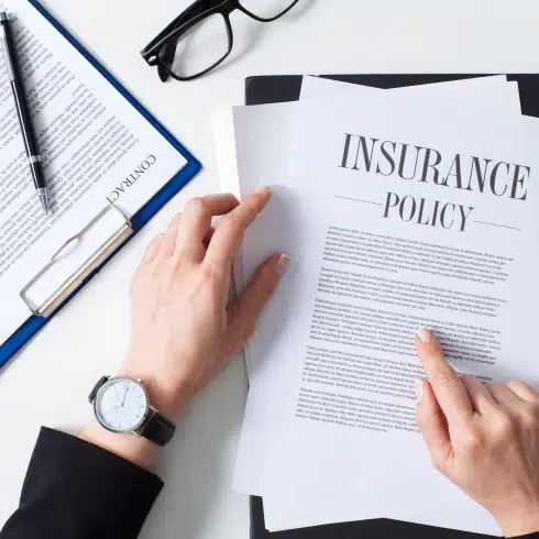close up of hands holding bad faith insurance claims documents