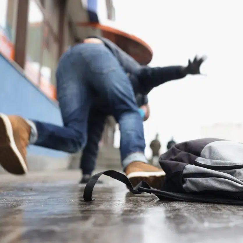 Close up of person get injury after falling on slippery ground in winter season.